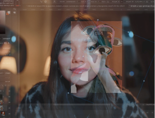 A woman sits looking at a screen, creating a unique collage image of eyes, hands and other images.