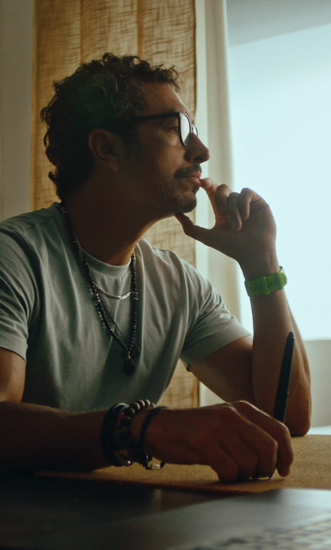 Filmmaker Antoni Sendra, staring thoughtfully at his editing workstation.